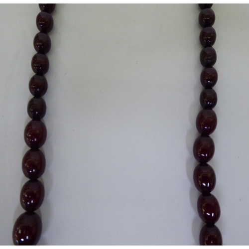 22 - A graduated cherry coloured amber bead necklace