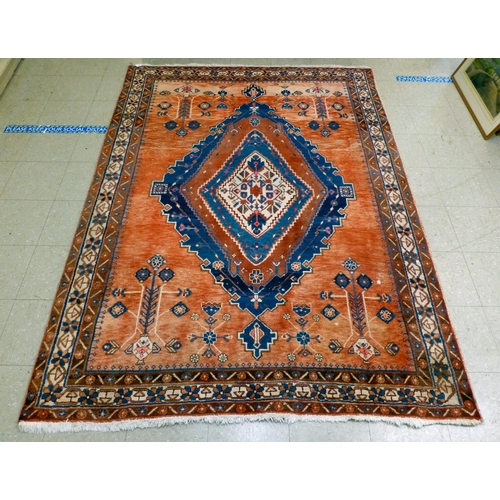 319 - A Persian rug, decorated with floral motifs, on a red and blue ground  72