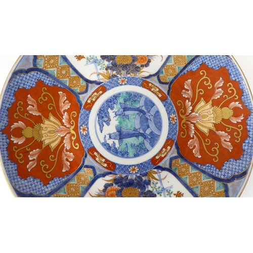 42 - A 20thC Japanese porcelain charger, decorated in colours and pictorial panels and on the obverse  be... 