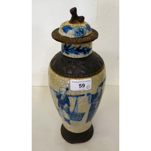 59 - A 20thC Chinese porcelain crackle glazed vase and cover, decorated with figures  12.5