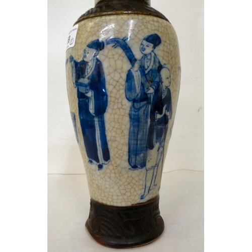 59 - A 20thC Chinese porcelain crackle glazed vase and cover, decorated with figures  12.5