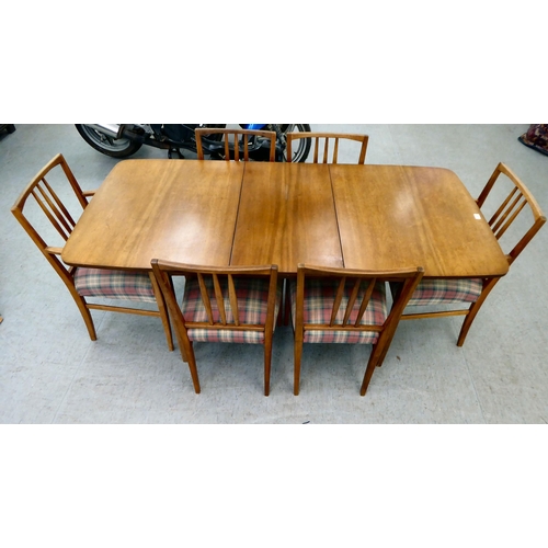 63 - A Gordon Russel teak dining table, raised on turned legs  30