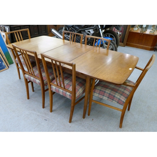 63 - A Gordon Russel teak dining table, raised on turned legs  30