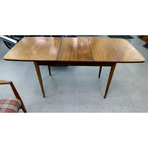 63 - A Gordon Russel teak dining table, raised on turned legs  30