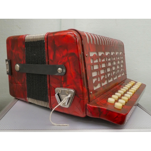 70 - A Rossini red marbleised effect cased button Melodeon with a hard carrying case