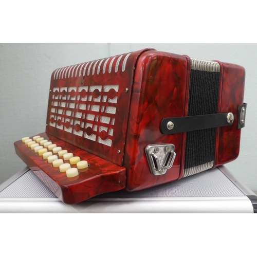 70 - A Rossini red marbleised effect cased button Melodeon with a hard carrying case