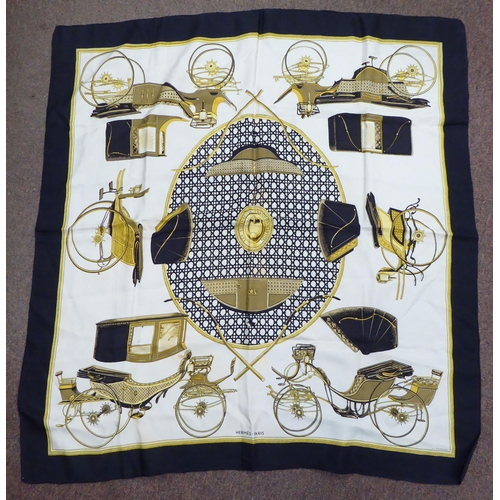 100 - A Hermes black, cream and gold coloured silk scarf  'Les Voitures a Transformation'  36