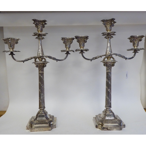 102 - A pair of late Victorian silver, two part candelabrum, each comprising twin scrolled branches, aroun... 