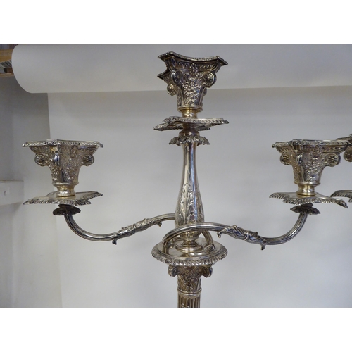 102 - A pair of late Victorian silver, two part candelabrum, each comprising twin scrolled branches, aroun... 