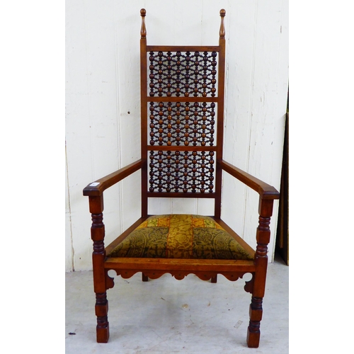 245 - A late Victorian oak framed Anglo-Moorish Liberty Cairene chair, illustrated in Liberty Furniture 18... 