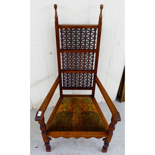 245 - A late Victorian oak framed Anglo-Moorish Liberty Cairene chair, illustrated in Liberty Furniture 18... 