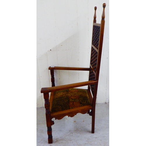 245 - A late Victorian oak framed Anglo-Moorish Liberty Cairene chair, illustrated in Liberty Furniture 18... 