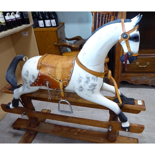 248 - An early 20thC overpainted nursery rocking horse, on an oak plinth  38