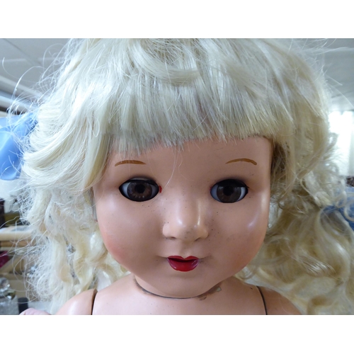 252 - Dolls: to include an early 20thC Thuringia Bisque head example with painted features and weighted sl... 