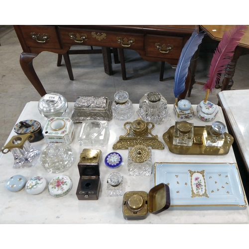 254 - Variously constructed inkwells: to include glass; china; and brass examples  largest 4