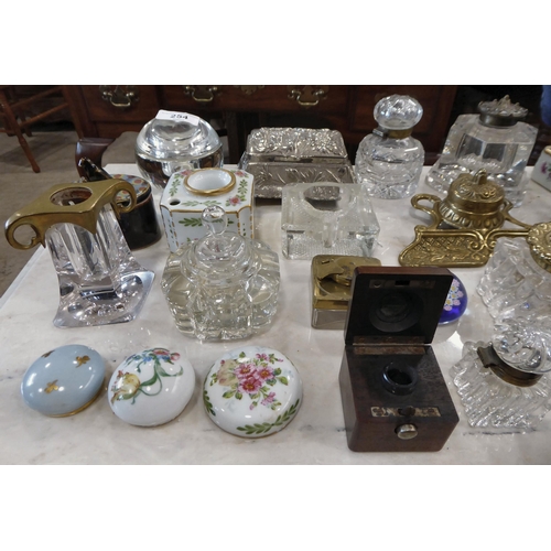 254 - Variously constructed inkwells: to include glass; china; and brass examples  largest 4