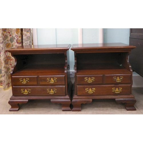 262 - A pair of modern mahogany bedside chests with an open shelf, over two long drawers, raised on bracke... 