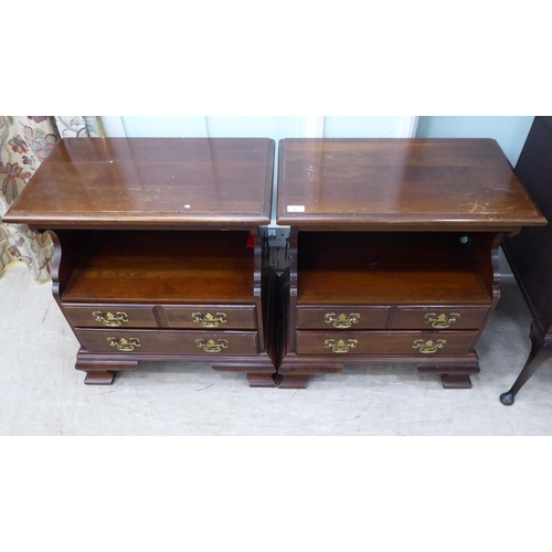 262 - A pair of modern mahogany bedside chests with an open shelf, over two long drawers, raised on bracke... 