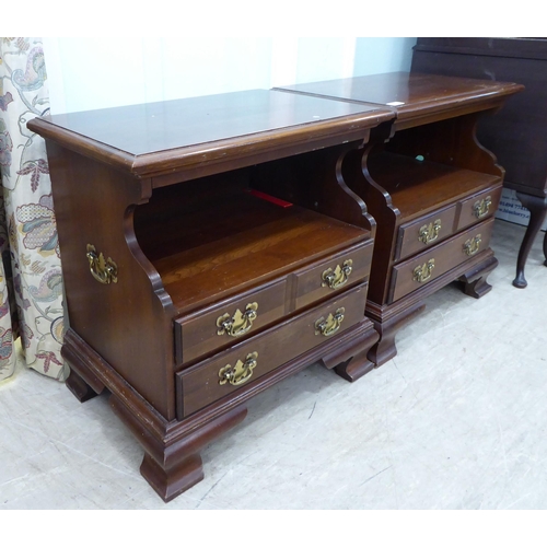 262 - A pair of modern mahogany bedside chests with an open shelf, over two long drawers, raised on bracke... 