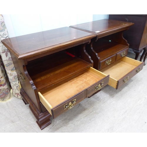 262 - A pair of modern mahogany bedside chests with an open shelf, over two long drawers, raised on bracke... 