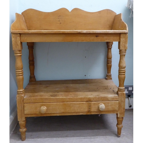 263 - An early 20thC rustic pine, two tier washstand, raised on turned and block legs  34