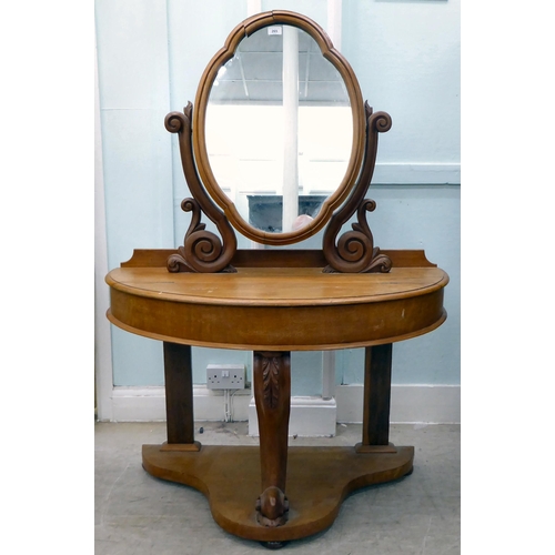 265 - A late Victorian Duchess style mahogany dressing table, surmounted by an oval mirror, over a hinged ... 