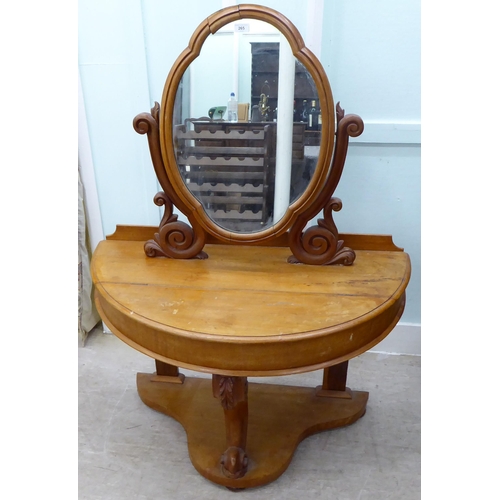 265 - A late Victorian Duchess style mahogany dressing table, surmounted by an oval mirror, over a hinged ... 