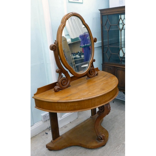 265 - A late Victorian Duchess style mahogany dressing table, surmounted by an oval mirror, over a hinged ... 