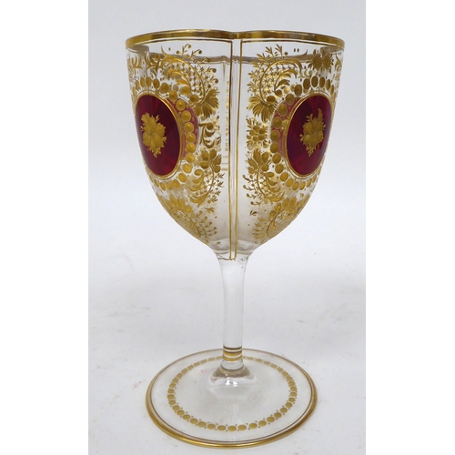 47 - A set of twelve late 19th/early 20thC lobed pedestal wine glasses, decorated with cranberry medallio... 