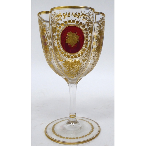 47 - A set of twelve late 19th/early 20thC lobed pedestal wine glasses, decorated with cranberry medallio... 