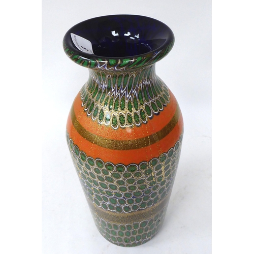 5 - A Murano glass vase, randomly decorated in gilding and coloured designs of baluster form with a flar... 