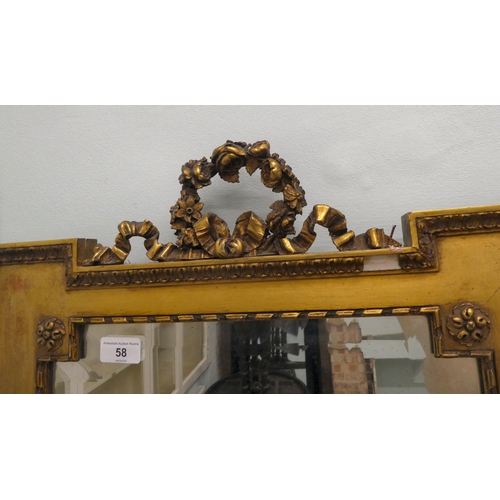 58 - An Edwardian bevelled mirror, set in a carved giltwood and gesso frame, incorporating rosettes and g... 