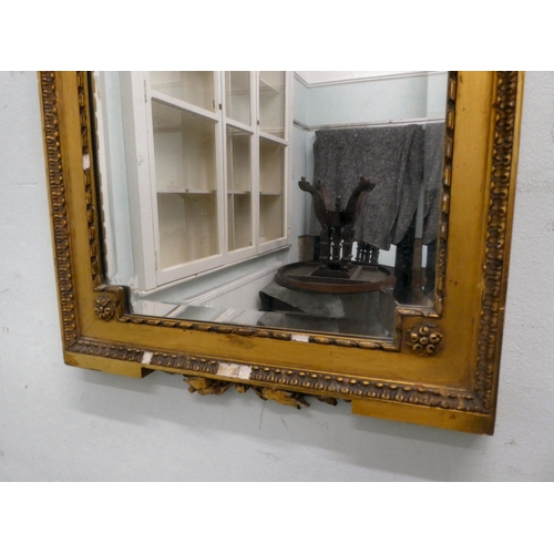 58 - An Edwardian bevelled mirror, set in a carved giltwood and gesso frame, incorporating rosettes and g... 