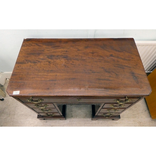 60 - A Georgian Chippendale influenced mahogany desk with canted, reed carved corners, the top incorporat... 