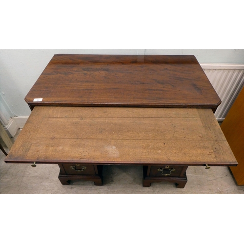 60 - A Georgian Chippendale influenced mahogany desk with canted, reed carved corners, the top incorporat... 