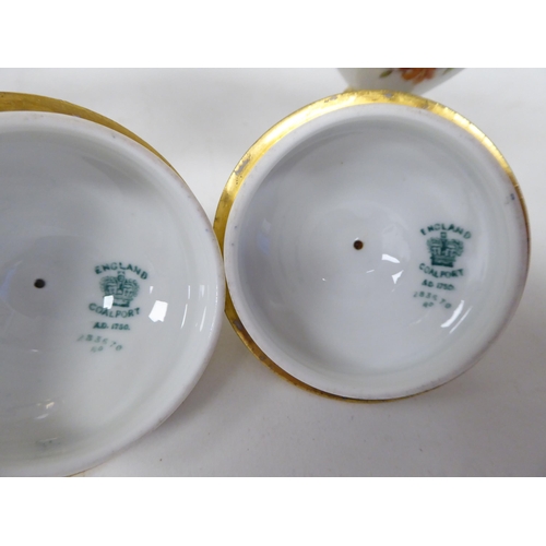 61 - A 20thC pair of Coalport china, ovoid shape, pedestal vases with covers and opposing ram's head hand... 