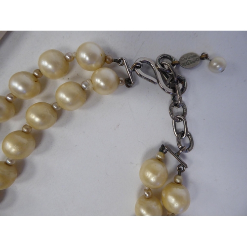 93 - Christian Dior, viz. a double strand, simulated pearl necklace, on an S-design clasp, in an original... 