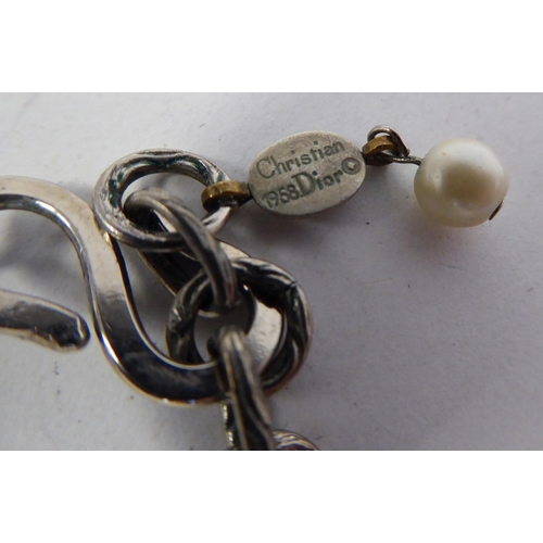 93 - Christian Dior, viz. a double strand, simulated pearl necklace, on an S-design clasp, in an original... 