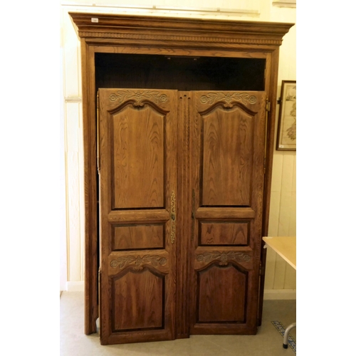 250 - A modern French inspired oak, twin door wardrobe with provisions for a hanging rail, over two open s... 