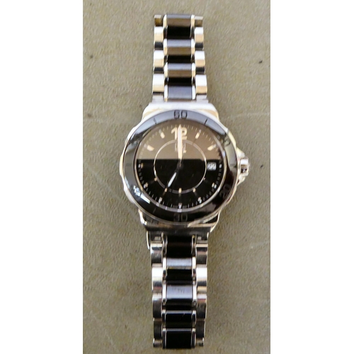 137 - A unisex Tag-Heuer stainless steel cased and strapped wristwatch, faced by a baton dial with a date ... 