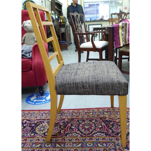 277 - A set of six modern puzzle back design, beech framed dining chairs with two-tone fabric upholstered ... 