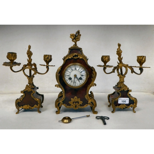 100 - A late 19thC French gilt metal mounted and laminated, three piece clock garniture with ornately cast... 