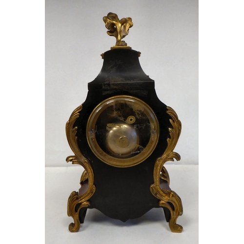 100 - A late 19thC French gilt metal mounted and laminated, three piece clock garniture with ornately cast... 