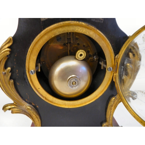 100 - A late 19thC French gilt metal mounted and laminated, three piece clock garniture with ornately cast... 