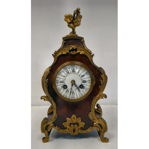 100 - A late 19thC French gilt metal mounted and laminated, three piece clock garniture with ornately cast... 