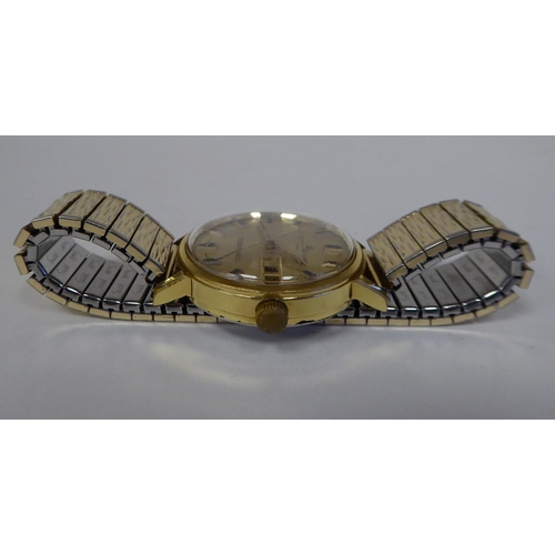 102 - A Baume & Mercier Tronosonic stainless steel cased bracelet wristwatch, faced by a gilded baton ... 