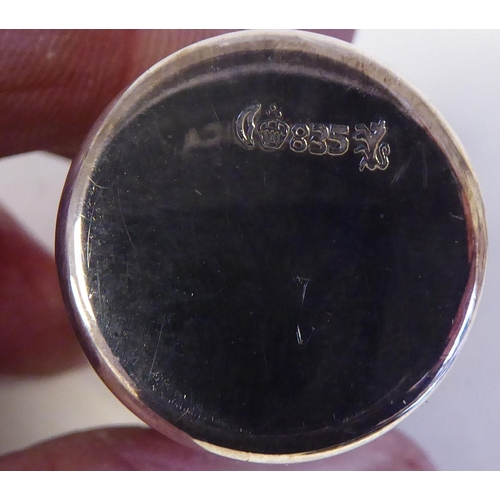 104 - A silver coloured metal liqueur set, comprising six tumbler cups, on an oval, wavy edged tray&nbsp; ... 