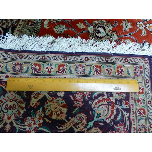 120 - A Qum design silk rug, decorated with a central medallion, surrounded and bordered by floral and bir... 