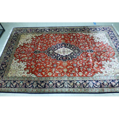 120 - A Qum design silk rug, decorated with a central medallion, surrounded and bordered by floral and bir... 