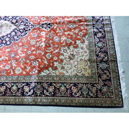120 - A Qum design silk rug, decorated with a central medallion, surrounded and bordered by floral and bir... 